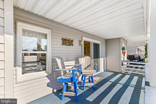 a living room with stainless steel appliances kitchen island granite countertop furniture and wooden floor
