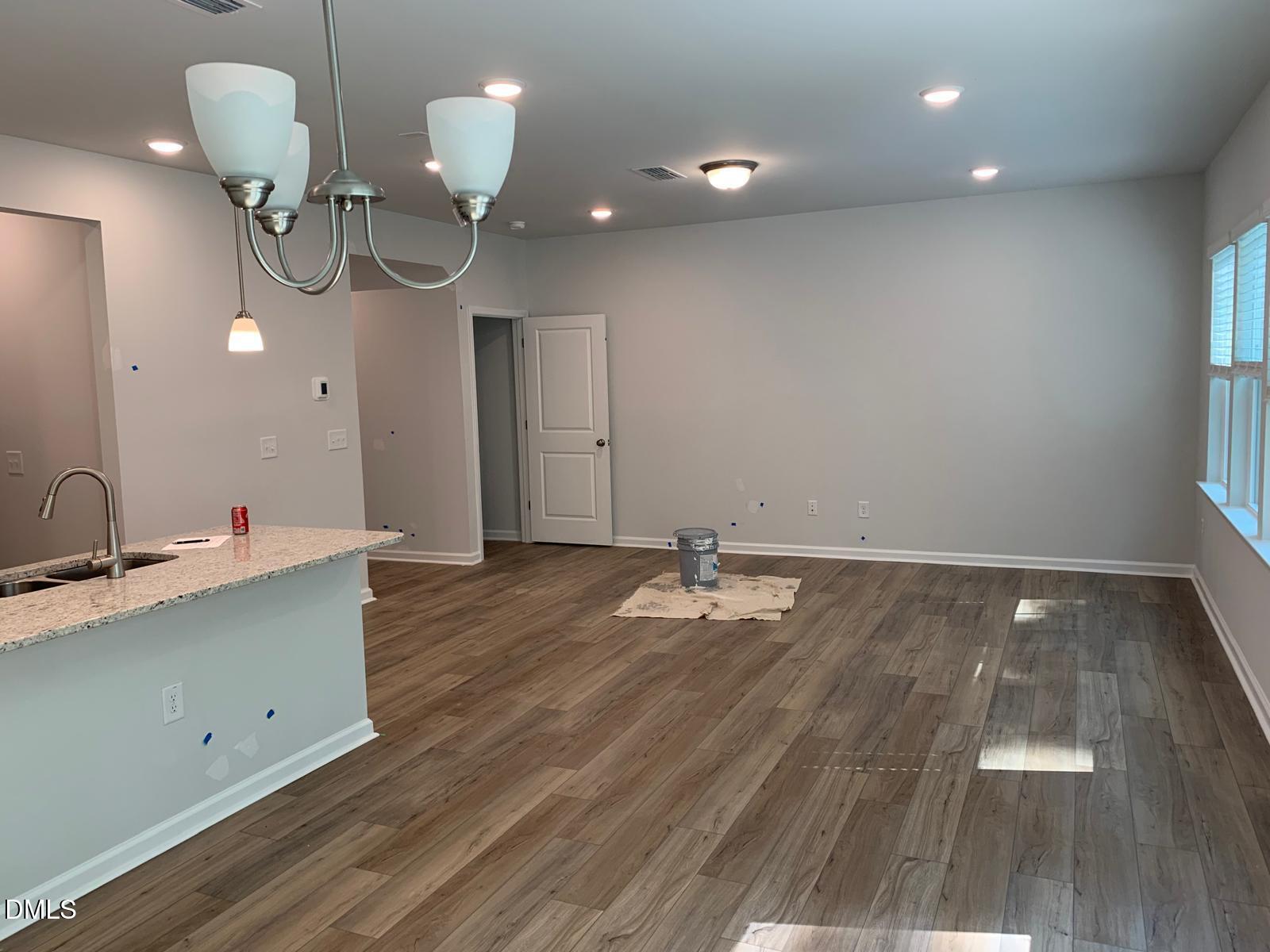233 Broomside Avenue Raleigh, NC 27603 - Photo 6 of 18 a view of a room with wooden floor