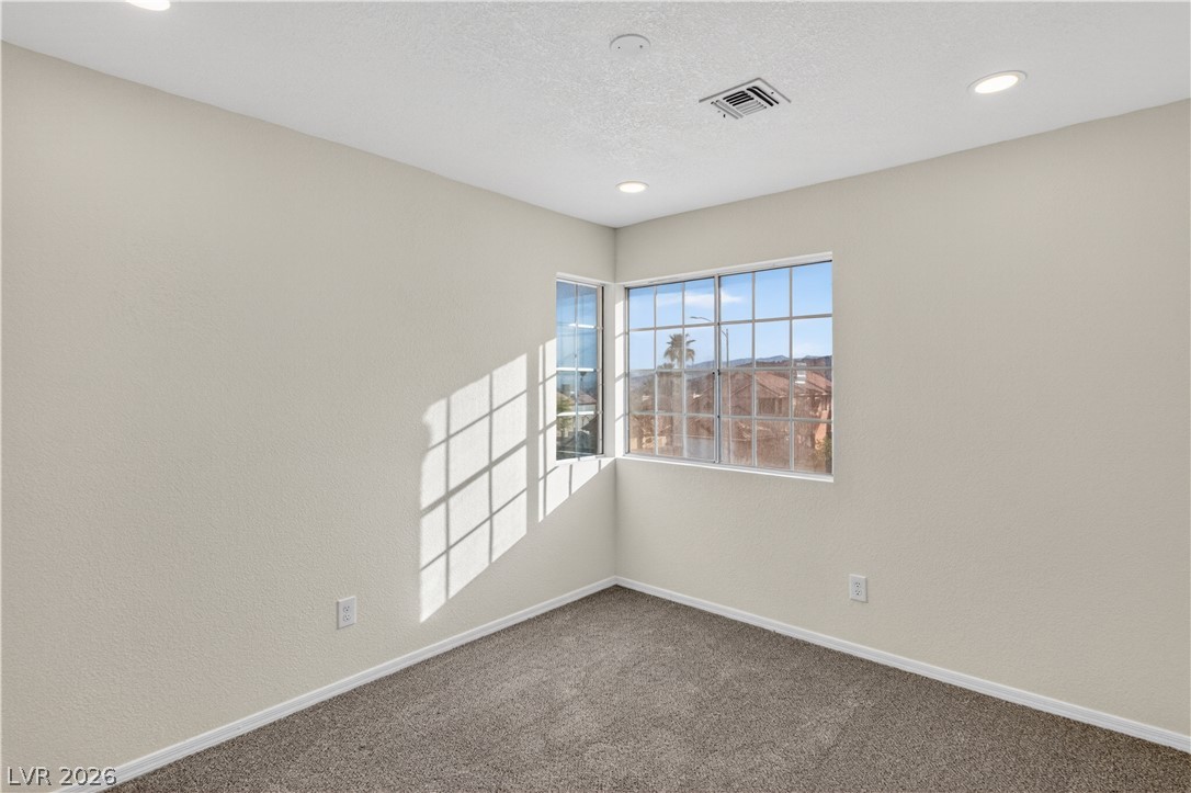 3156 Terrace View Drive Laughlin, NV 89029 - Photo 39 of 94 Sun-filled corner windows illuminate this comfortable, carpeted room, creating a pleasant atmosphere.