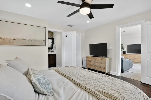 a bedroom with a bed and a flat screen tv