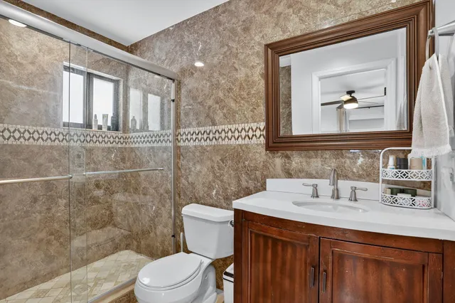 a bathroom with a sink a toilet and mirror