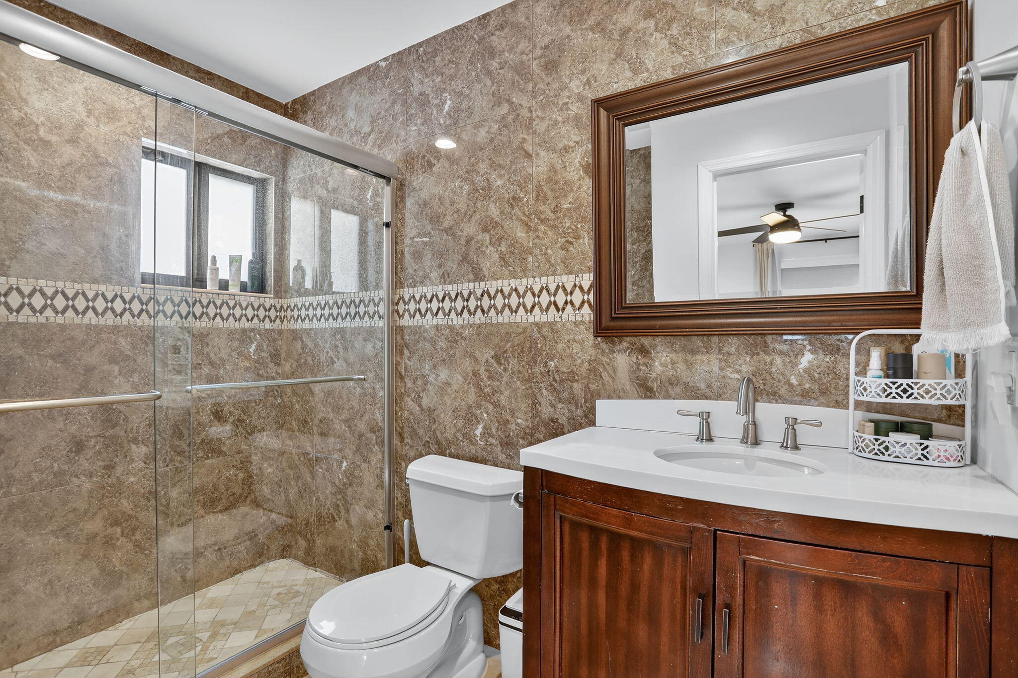 2840 Northeast 7th Terrace Pompano Beach, FL 33064 - Photo 17 of 42 a bathroom with a sink a toilet and mirror