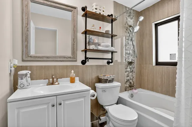 a bathroom with a sink toilet tub and shower