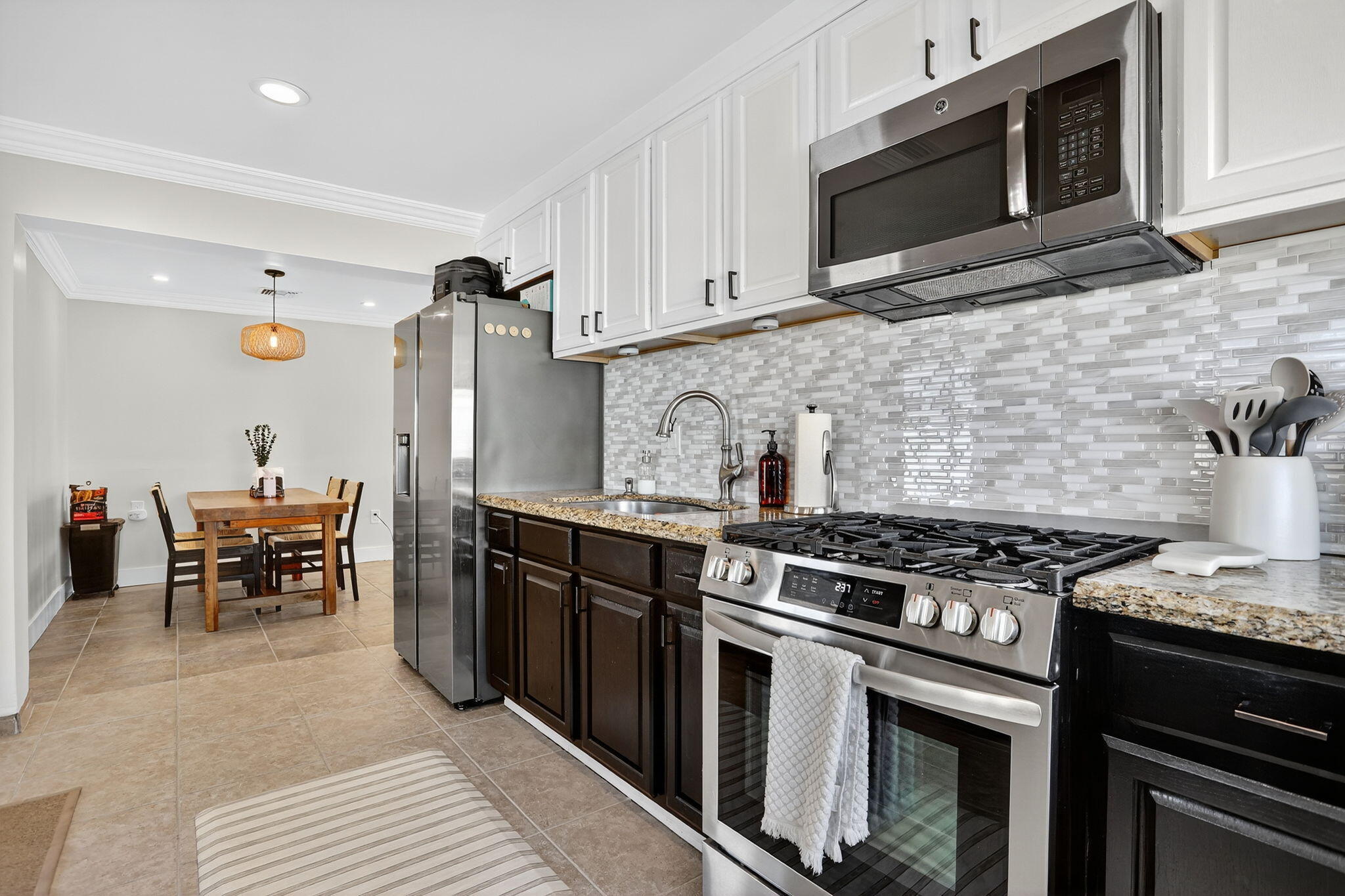 2840 Northeast 7th Terrace Pompano Beach, FL 33064 - Photo 2 of 42 a kitchen with stainless steel appliances granite countertop a stove and a microwave
