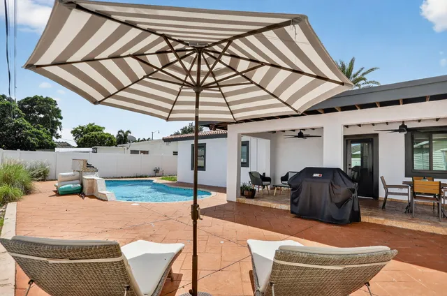 a building outdoor space with patio furniture and potted plants