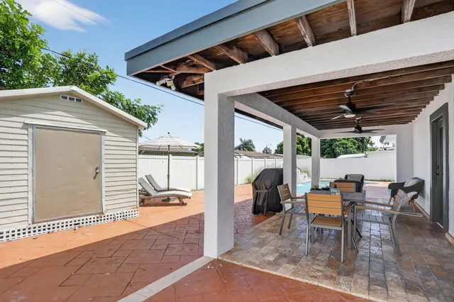 a view of roof deck with table and chairs and wooden floor