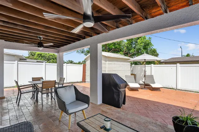 a view of a patio with table and chairs and potted plants