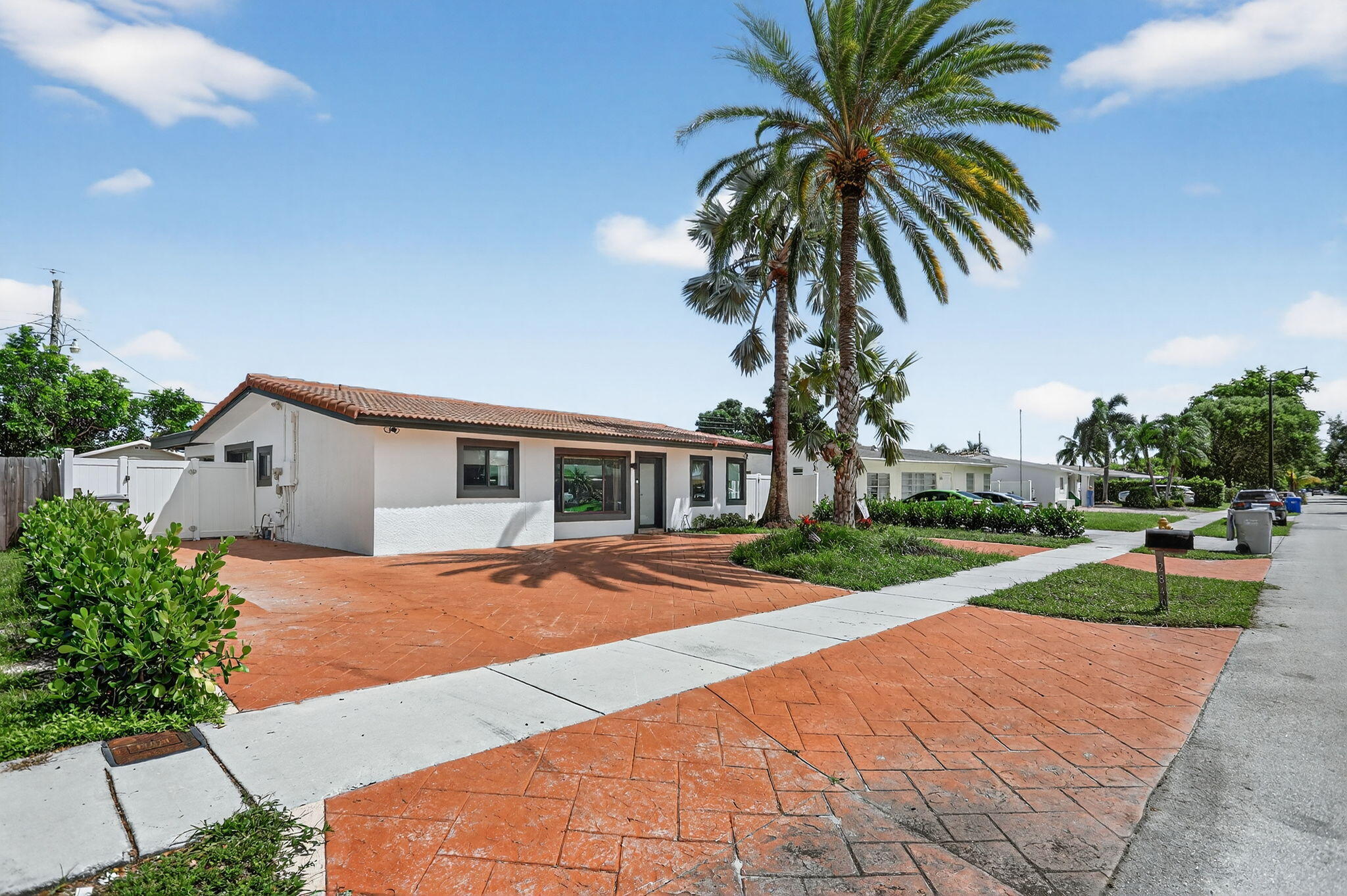 2840 Northeast 7th Terrace Pompano Beach, FL 33064 - Photo 30 of 42 a front view of house with yard and trees