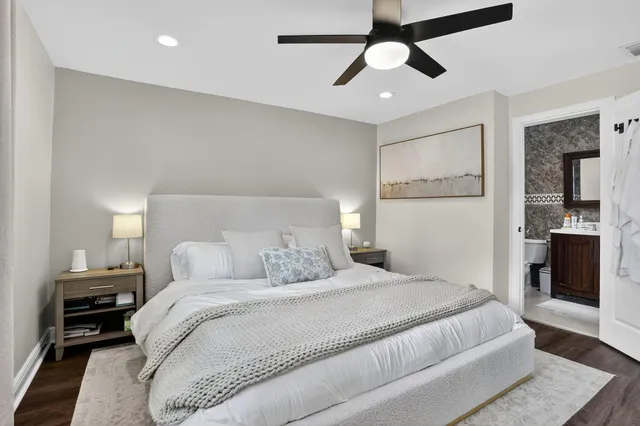 a bedroom with a large bed and a chandelier