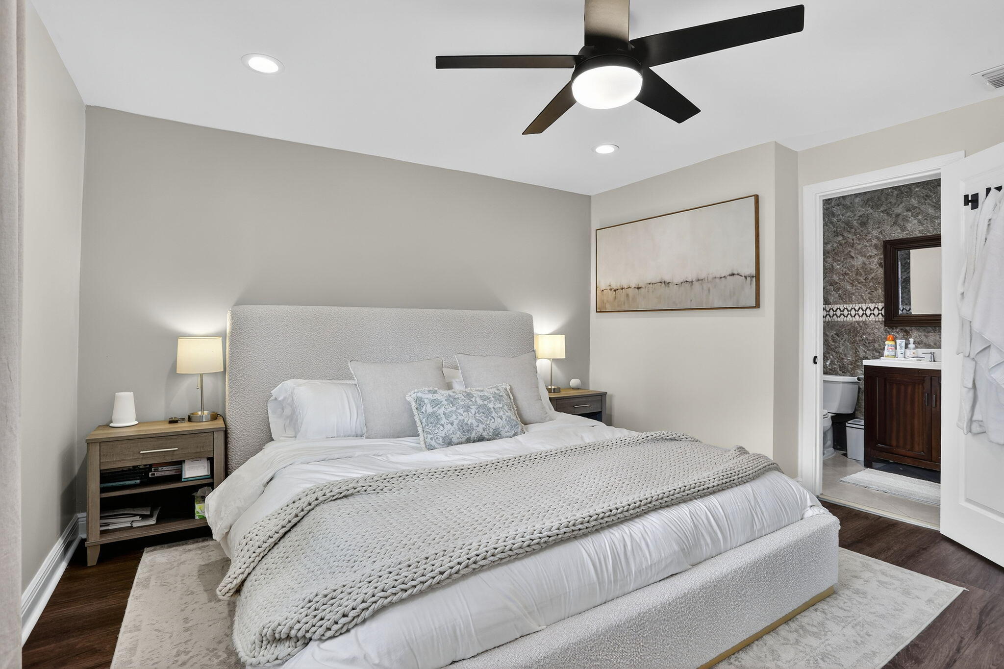 2840 Northeast 7th Terrace Pompano Beach, FL 33064 - Photo 3 of 42 a bedroom with a large bed and a chandelier