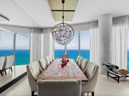 a large kitchen with stainless steel appliances and a counter top space