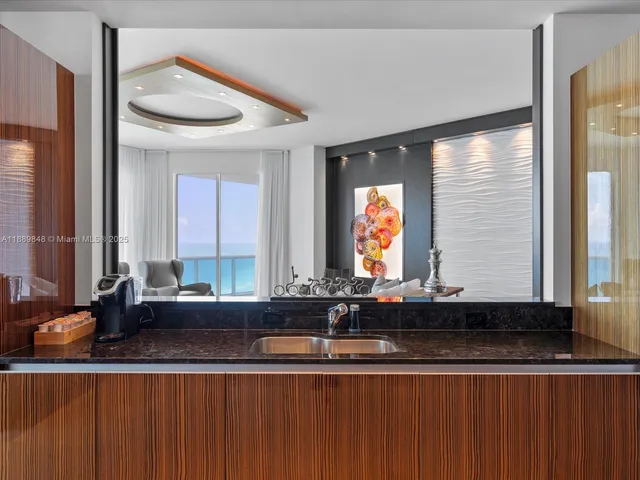 a view of a bedroom with wooden floor fireplace and windows