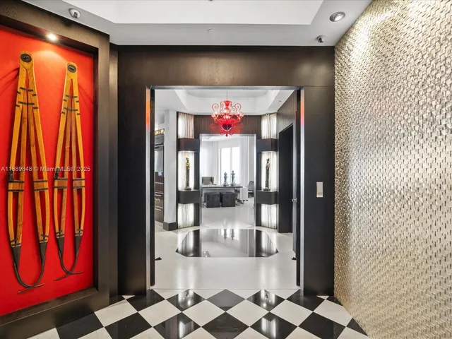 a hallway with a black white checkered floor and a large window with balcony view