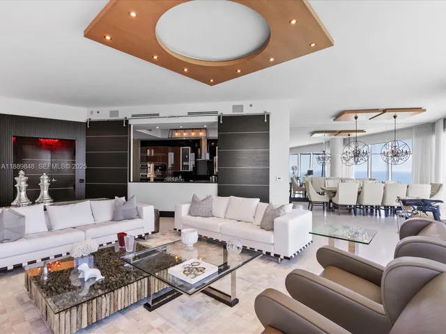 a living room with furniture and a floor to ceiling window