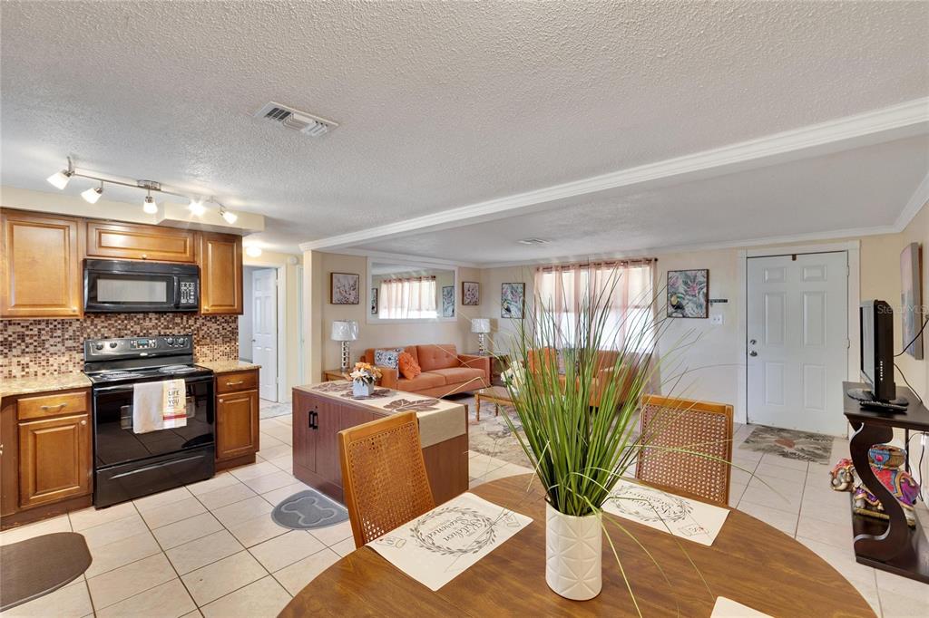 10801 Fillmore Avenue Port Richey, FL 34668 - Photo 14 of 29 a living room with stainless steel appliances furniture cabinets and a counter top space