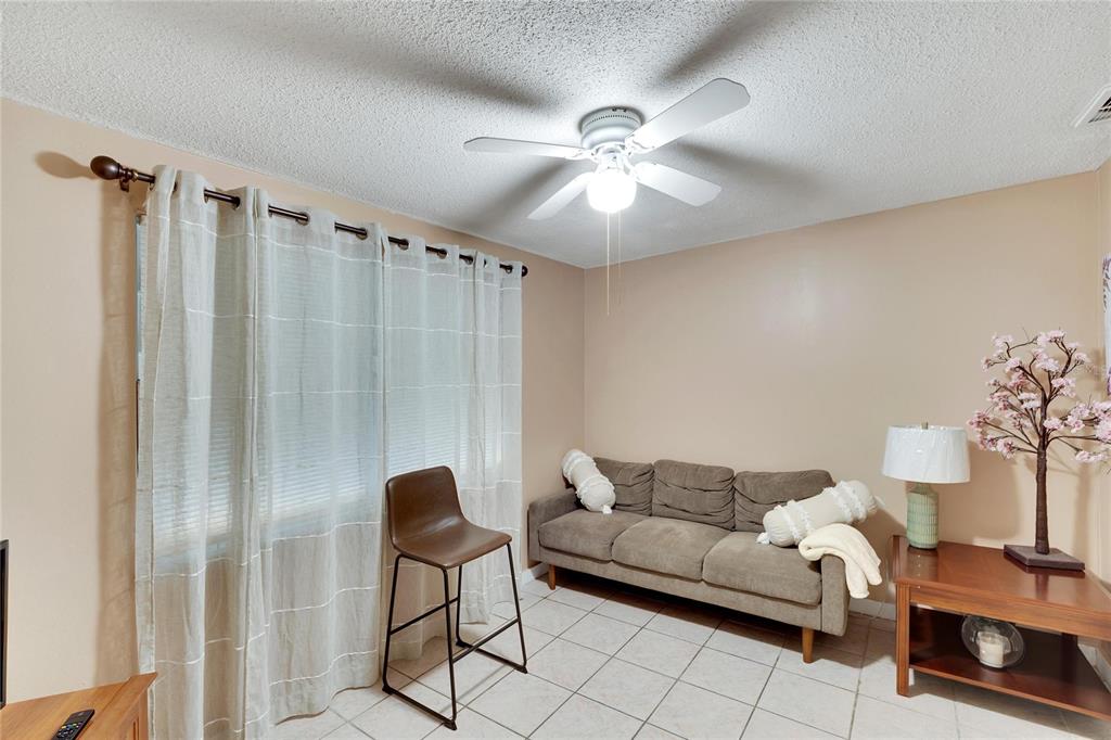 10801 Fillmore Avenue Port Richey, FL 34668 - Photo 21 of 29 a living room with furniture and a chandelier