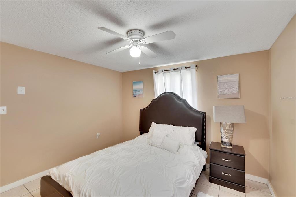 10801 Fillmore Avenue Port Richey, FL 34668 - Photo 24 of 29 a bedroom with a bed and a lamp