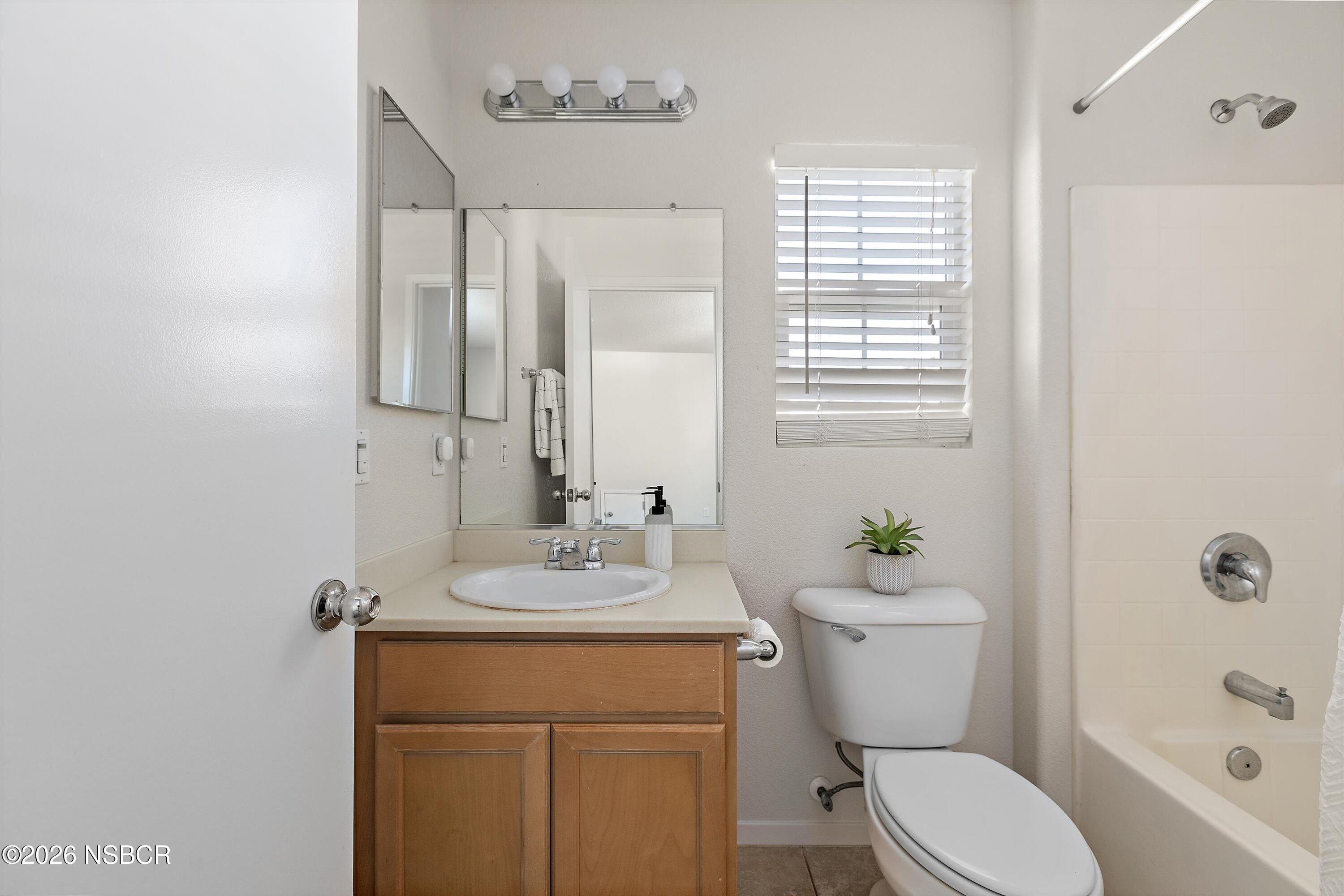 2020 Green Ridge Circle Lompoc, CA 93436 - Photo 14 of 20 a bathroom with a sink a toilet a mirror and shower