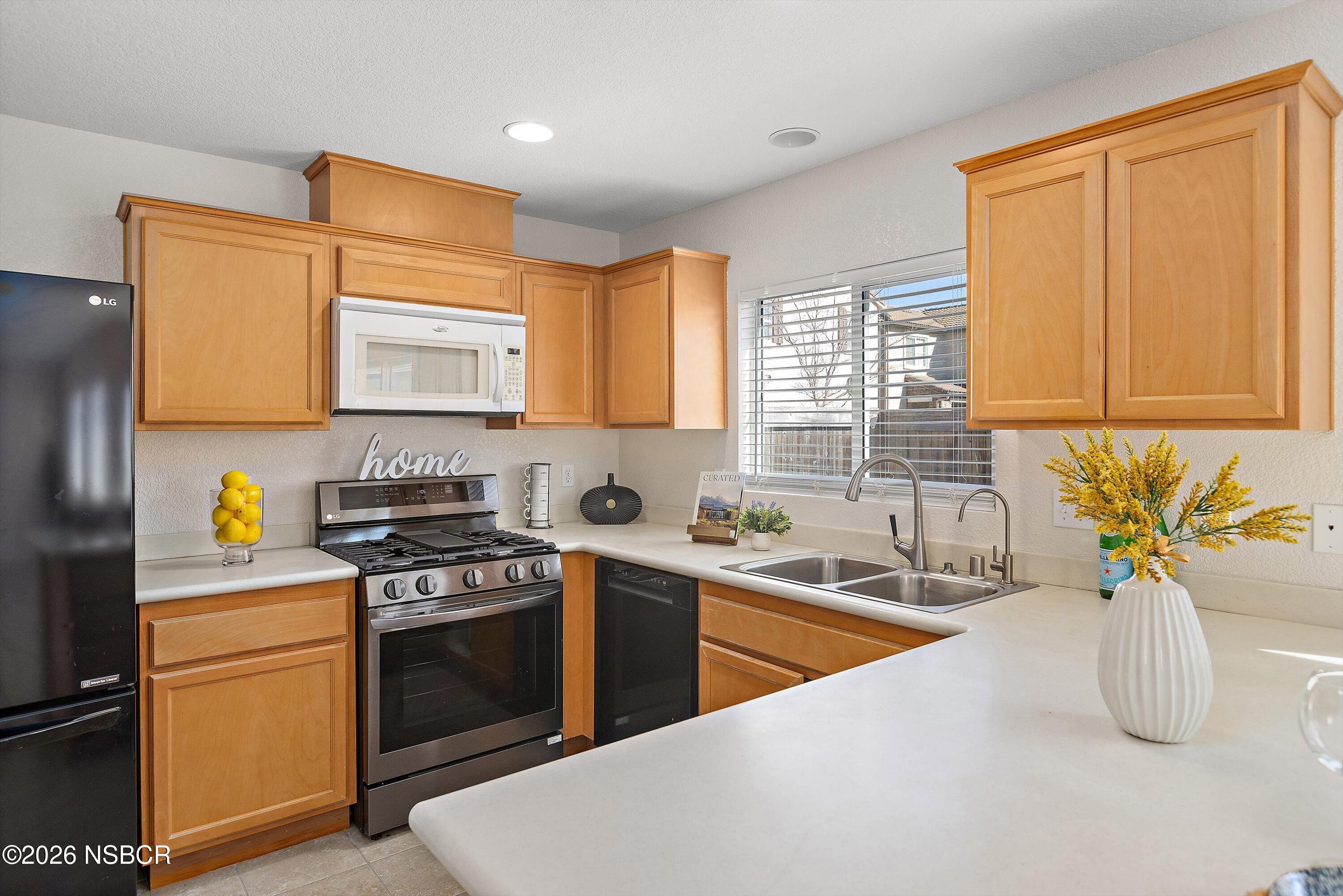 2020 Green Ridge Circle Lompoc, CA 93436 - Photo 8 of 20 a kitchen with stainless steel appliances granite countertop a sink a stove and a refrigerator
