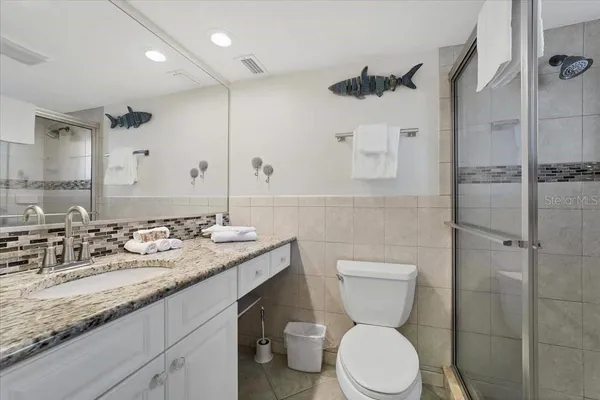 a bathroom with a toilet sink and shower