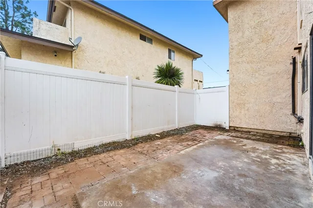 a view of a patio with couches and a potted plant