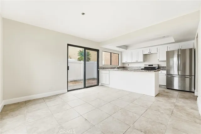 a kitchen with stainless steel appliances granite countertop a refrigerator sink and cabinets