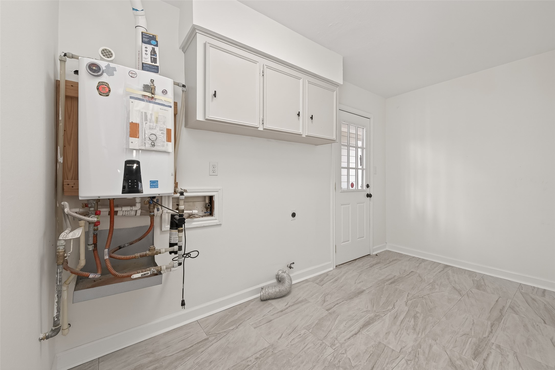 6211 Allentown Drive Spring, TX 77389 - Photo 19 of 39 Tankless water heater in laundry room.