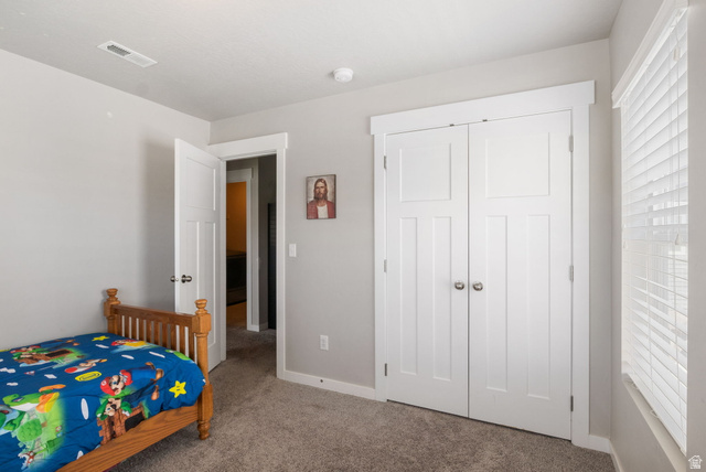 5155 East Rio Grande Way Eagle Mountain, UT 84005 - Photo 27 of 40 Carpeted bedroom featuring multiple windows and a closet