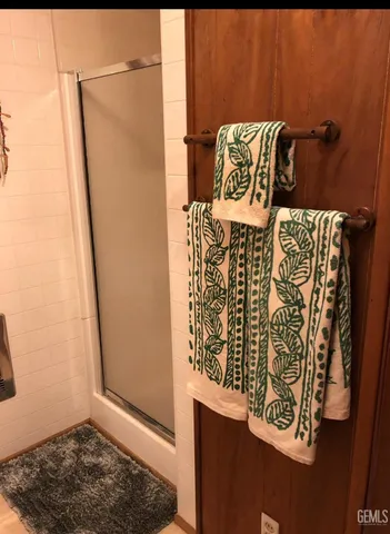 a bathroom with a shower and a mirror