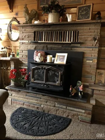 a kitchen with a stove a fireplace and cabinets