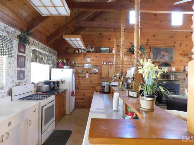 a kitchen with lots of counter top space and wooden floor