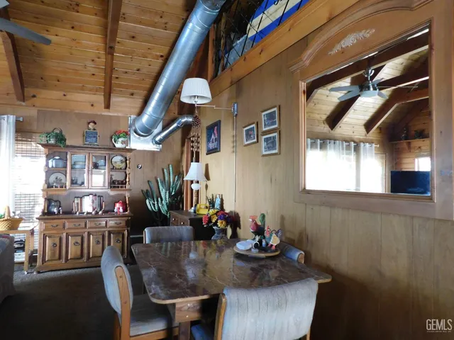 a view of a dining room with furniture and a chandelier