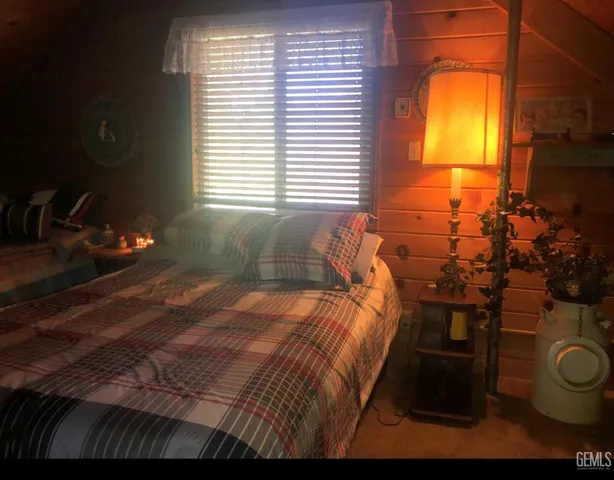 a bed sitting in a bedroom next to a window