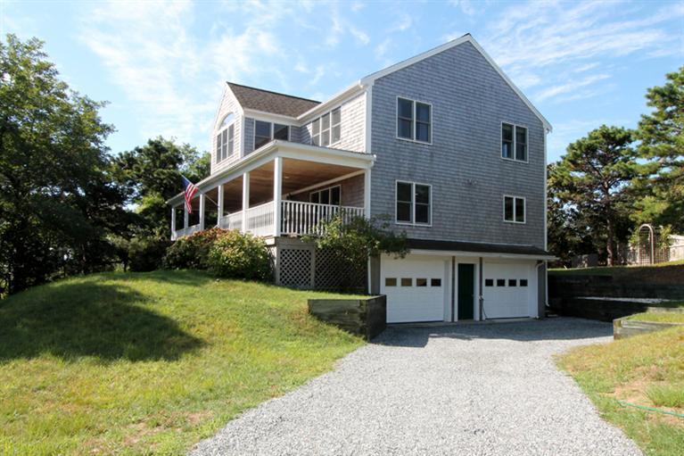 1570 Samoset Road Eastham, MA 02642 - Photo 3 of 34 a front view of a house with a yard
