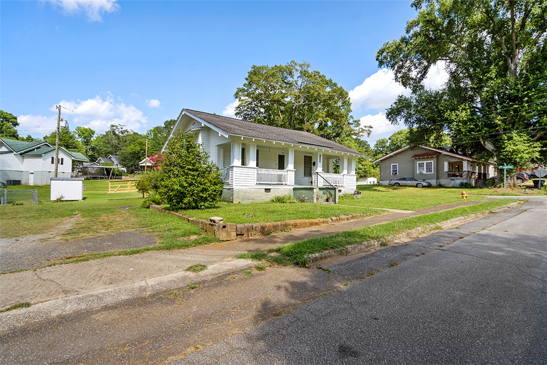 200 Louisiana Street Honea Path, SC 29654 - Photo 12 of 13 A classic bungalow with a welcoming front porch, nestled on a verdant lot.