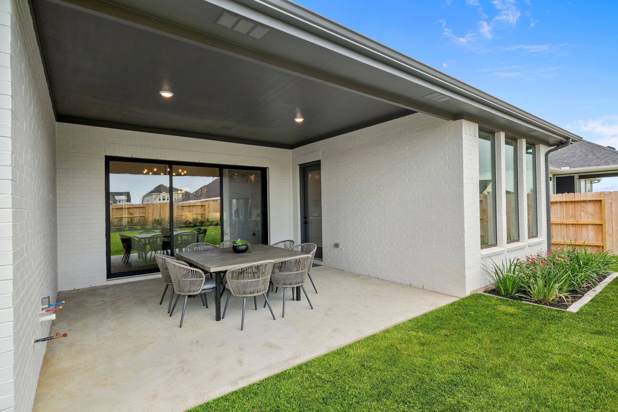 721 Cross Timbers Trace Hempstead, TX 77445 - Photo 15 of 22 a patio with a table and chairs and potted plants