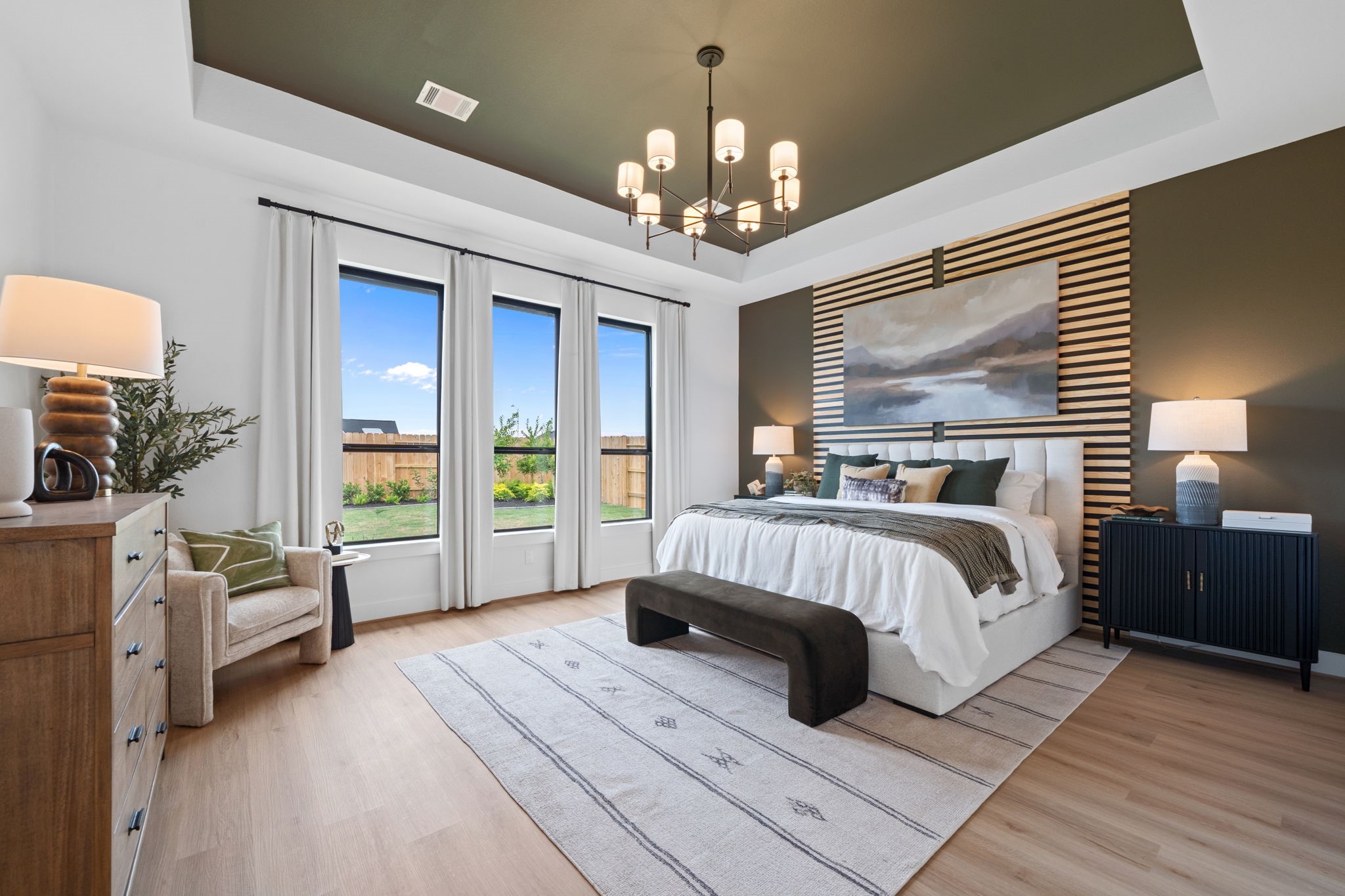 721 Cross Timbers Trace Hempstead, TX 77445 - Photo 10 of 22 a spacious bedroom with a large bed and a chandelier