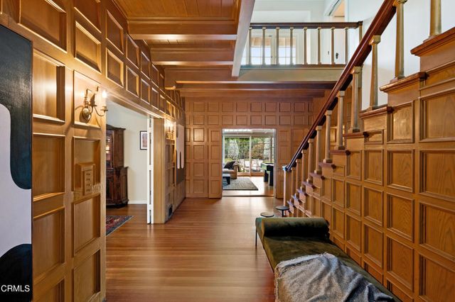 a view of an entryway with wooden floor and door