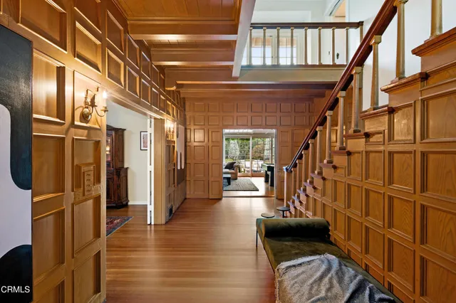 a view of an entryway with wooden floor and door