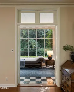 a living room with furniture and a floor to ceiling window