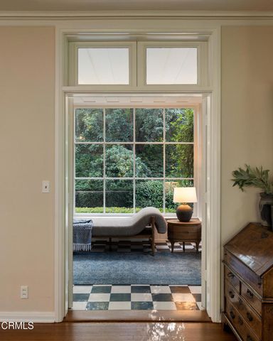 a living room with furniture and a floor to ceiling window