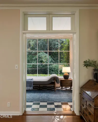 a living room with furniture and a floor to ceiling window