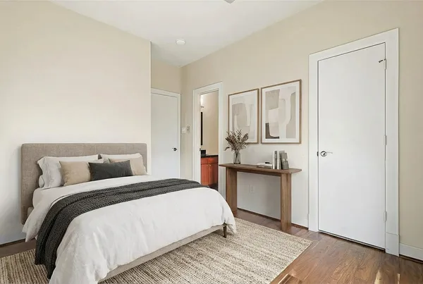 a bedroom with a bed and wooden floor