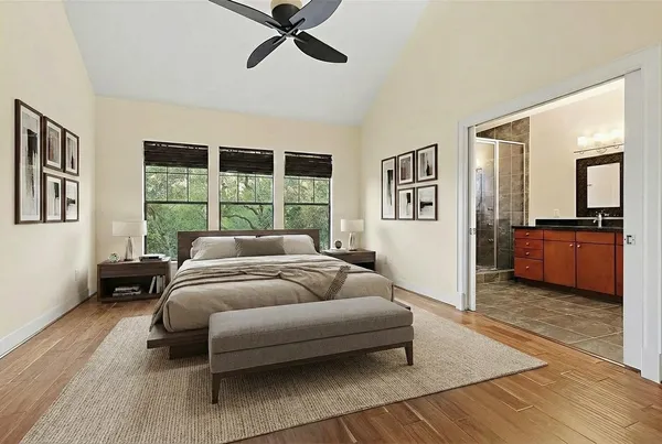 a bedroom with a bed and wooden floor