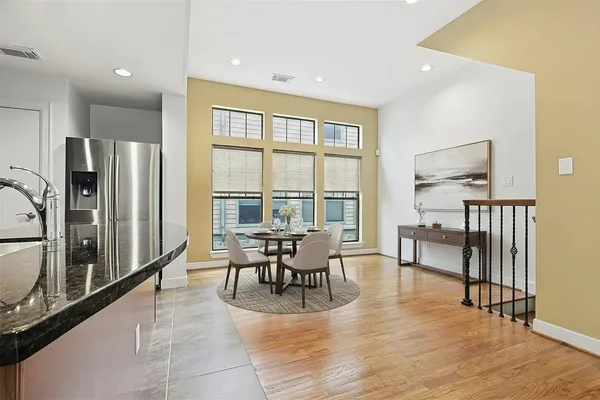a view of a dining room with furniture window and wooden floor