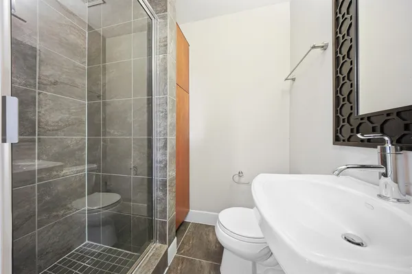 a bathroom with a sink toilet and shower