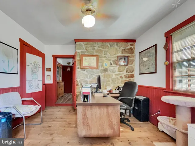 a view of a room with workspace and wooden floor