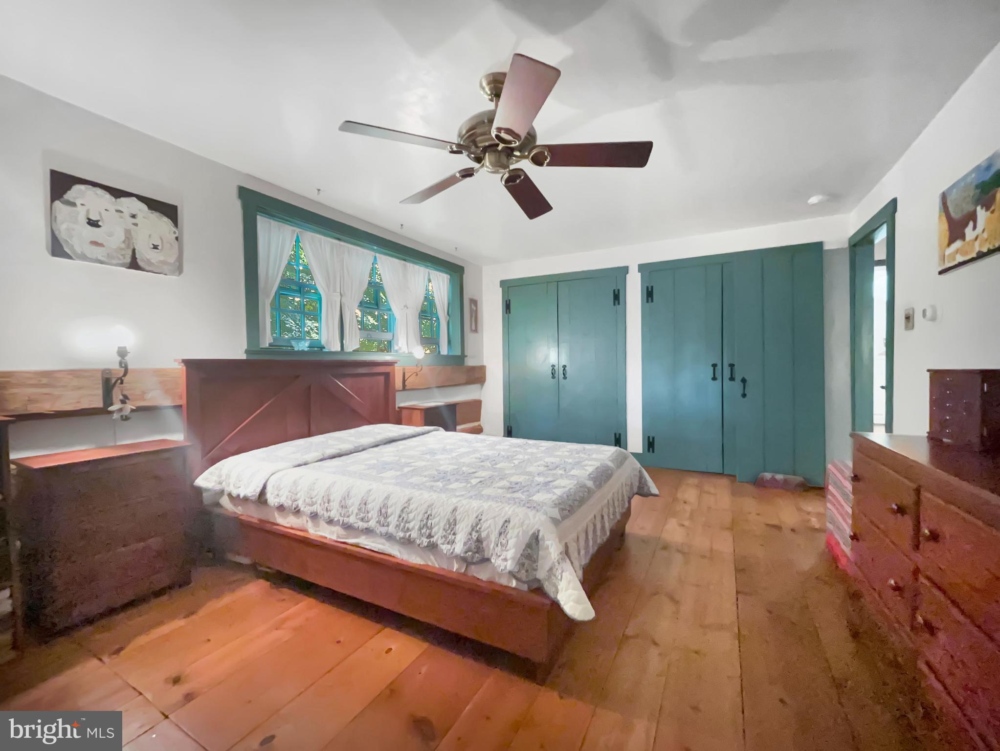 1095 Texter Mountain Road Denver, PA 17517 - Photo 16 of 37 a bedroom with a large bed and a chandelier