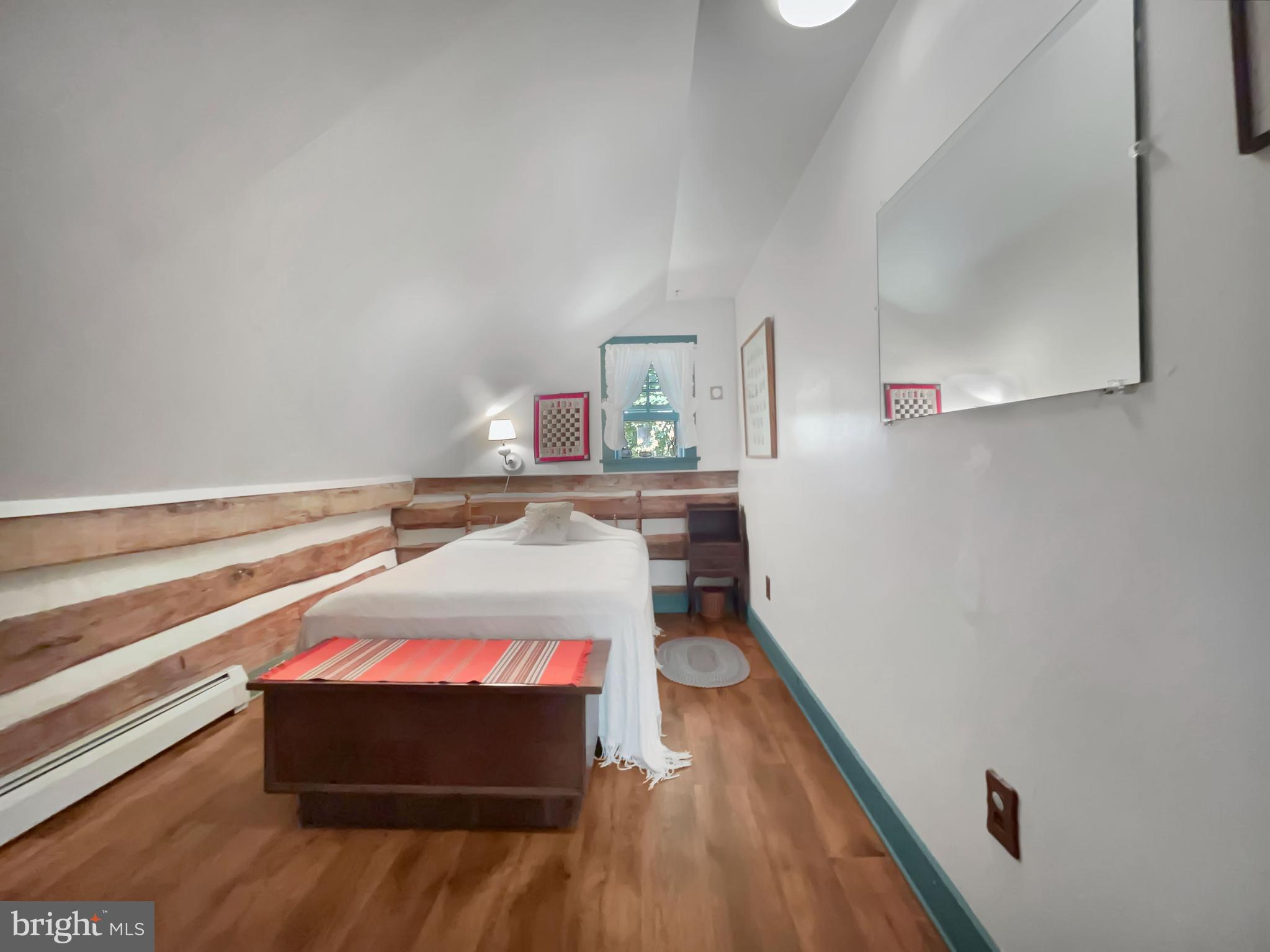 1095 Texter Mountain Road Denver, PA 17517 - Photo 22 of 37 a room with a bed and wooden floor