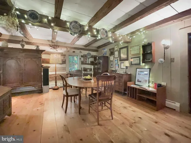 a dining room with furniture a kitchen view and a chandelier